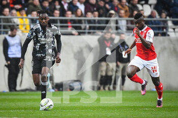 2022-03-20 - Karl TOKO EKAMBI of Lyon and Ghislain KONAN of Reims during the French championship Ligue 1 football match between Stade de Reims and Olympique Lyonnais on March 20, 2022 at Auguste Delaune stadium in Reims, France - STADE DE REIMS VS OLYMPIQUE LYONNAIS - FRENCH LIGUE 1 - SOCCER