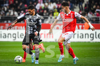 2022-03-20 - Houssem AOUAR of Lyon and Maxime BUSI of Reims during the French championship Ligue 1 football match between Stade de Reims and Olympique Lyonnais on March 20, 2022 at Auguste Delaune stadium in Reims, France - STADE DE REIMS VS OLYMPIQUE LYONNAIS - FRENCH LIGUE 1 - SOCCER