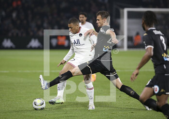 2022-04-20 - Kylian Mbappe of PSG, Romain Thomas of Angers during the French championship Ligue 1 football match between SCO Angers and Paris Saint-Germain on April 20, 2022 at Raymond Kopa stadium in Angers, France - SCO ANGERS VS PARIS SAINT-GERMAIN - FRENCH LIGUE 1 - SOCCER