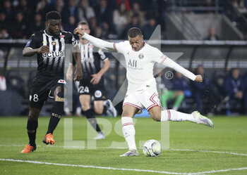 2022-04-20 - Kylian Mbappe of PSG, Ismael Traore of Angers (left) during the French championship Ligue 1 football match between SCO Angers and Paris Saint-Germain on April 20, 2022 at Raymond Kopa stadium in Angers, France - SCO ANGERS VS PARIS SAINT-GERMAIN - FRENCH LIGUE 1 - SOCCER