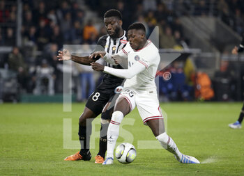 2022-04-20 - Ismael Traore of Angers, Nuno Mendes of PSG during the French championship Ligue 1 football match between SCO Angers and Paris Saint-Germain on April 20, 2022 at Raymond Kopa stadium in Angers, France - SCO ANGERS VS PARIS SAINT-GERMAIN - FRENCH LIGUE 1 - SOCCER