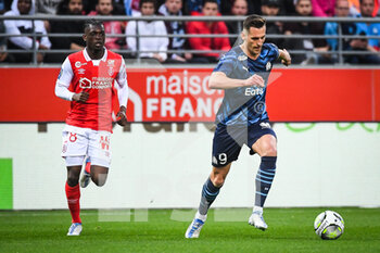 2022-04-24 - Banzouzi (Bradley) LOCKO of Reims and Arkadiusz MILIK of Marseille during the French championship Ligue 1 football match between Stade de Reims and Olympique de Marseille on April 24, 2022 at Auguste Delaune stadium in Reims, France - STADE DE REIMS VS OLYMPIQUE DE MARSEILLE - FRENCH LIGUE 1 - SOCCER