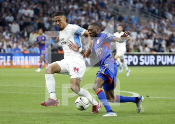 2022-05-01 - Karl Toko Ekambi of Lyon, William Saliba of Marseille (left) during the French championship Ligue 1 football match between Olympique de Marseille (OM) and Olympique Lyonnais (OL, Lyon) on May 1, 2022 at Stade Velodrome in Marseille, France - OLYMPIQUE DE MARSEILLE (OM) VS OLYMPIQUE LYONNAIS (OL, LYON) - FRENCH LIGUE 1 - SOCCER