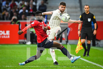 2022-05-06 - Jonathan BAMBA of Lille and Caio HENRIQUE of Monaco during the French championship Ligue 1 football match between LOSC Lille and AS Monaco on May 6, 2022 at Pierre Mauroy stadium in Villeneuve-d'Ascq near Lille, France - LOSC LILLE VS AS MONACO - FRENCH LIGUE 1 - SOCCER
