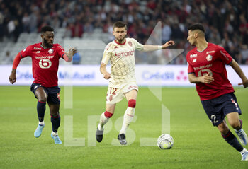 2022-05-06 - Caio Henrique of Monaco, Jonathan Bamba of Lille (left) during the French championship Ligue 1 football match between Lille OSC (LOSC) and AS Monaco (ASM) on May 6, 2022 at Stade Pierre Mauroy in Villeneuve d'Ascq near Lille, France - LOSC LILLE VS AS MONACO - FRENCH LIGUE 1 - SOCCER