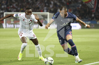 2022-05-21 - Kylian Mbappe of PSG, Pape Matar Sarr of FC Metz (left) during the French championship Ligue 1 football match between Paris Saint-Germain (PSG) and FC Metz on May 21, 2022 at Parc des Princes stadium in Paris, France - PARIS SAINT-GERMAIN (PSG) VS FC METZ - FRENCH LIGUE 1 - SOCCER