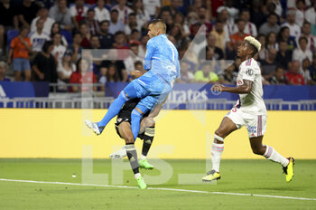 2022-08-05 - Goalkeeper of Lyon Anthony Lopes hits Mounaim El Idrissy of Ajaccio and will receive a direct red card for it, right Thiago Mendes of Lyon during the French championship Ligue 1 football match between Olympique Lyonnais (OL) and AC Ajaccio (ACA) on August 5, 2022 at Groupama Stadium in Decines-Charpieu near Lyon, France - FOOTBALL - FRENCH CHAMP - LYON V AJACCIO - FRENCH LIGUE 1 - SOCCER