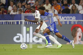 2022-08-19 - Wilson ODOBERT of Troyes and Castello LUKEBA of Lyon during the French championship Ligue 1 football match between Olympique Lyonnais (Lyon) and ESTAC Troyes on August 19, 2022 at Groupama stadium in Decines-Charpieu near Lyon, France - FOOTBALL - FRENCH CHAMP - LYON V TROYES - FRENCH LIGUE 1 - SOCCER