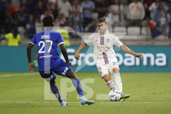 2022-08-19 - Nicolas TAGLIAFICO of Lyon and Kyliane DONG of Troyes during the French championship Ligue 1 football match between Olympique Lyonnais (Lyon) and ESTAC Troyes on August 19, 2022 at Groupama stadium in Decines-Charpieu near Lyon, France - FOOTBALL - FRENCH CHAMP - LYON V TROYES - FRENCH LIGUE 1 - SOCCER