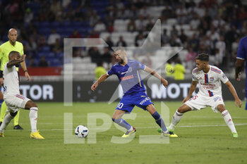 2022-08-19 - Florian TARDIEU of Troyes and Romain FAIVRE of Lyon and Alexandre LACAZETTE of Lyon during the French championship Ligue 1 football match between Olympique Lyonnais (Lyon) and ESTAC Troyes on August 19, 2022 at Groupama stadium in Decines-Charpieu near Lyon, France - FOOTBALL - FRENCH CHAMP - LYON V TROYES - FRENCH LIGUE 1 - SOCCER