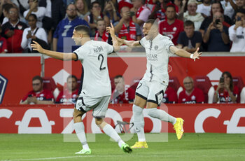 2022-08-21 - Kylian Mbappe of PSG celebrates his first goal with Achraf Hakimi (left) during the French championship Ligue 1 football match between LOSC Lille and Paris Saint-Germain on August 21, 2022 at Stade Pierre Mauroy in Villeneuve-d'Ascq near Lille, France - FOOTBALL - FRENCH CHAMP - LILLE V PARIS SG - FRENCH LIGUE 1 - SOCCER