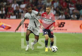 2022-08-21 - Edon Zhegrova of Lille, Presnel Kimpembe of PSG (left) during the French championship Ligue 1 football match between LOSC Lille and Paris Saint-Germain on August 21, 2022 at Stade Pierre Mauroy in Villeneuve-d'Ascq near Lille, France - FOOTBALL - FRENCH CHAMP - LILLE V PARIS SG - FRENCH LIGUE 1 - SOCCER