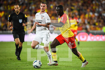 2022-08-27 - Benjamin BOURIGEAUD of Rennes and Deiver MACHADO of Lens during the French championship Ligue 1 football match between RC Lens and Stade Rennais (Rennes) on August 27, 2022 at Bollaert-Delelis stadium in Lens, France - FOOTBALL - FRENCH CHAMP - LENS V RENNES - FRENCH LIGUE 1 - SOCCER