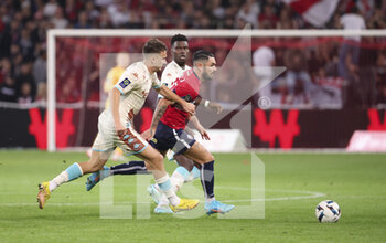 23/10/2022 - Remy Cabella of Lille between Aleksandr Golovin and Benoit Badiashile of Monaco during the French championship Ligue 1 football match between Lille OSC (LOSC) and AS Monaco (ASM) on October 23, 2022 at Stade Pierre Mauroy in Villeneuve-d'Ascq near Lille, France - FOOTBALL - FRENCH CHAMP - LILLE V MONACO - FRENCH LIGUE 1 - CALCIO
