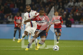 2022-10-30 - Tiago EMBALO DJALO of Lille and Alexandre LACAZETTE of Lyon during the French championship Ligue 1 football match between Olympique Lyonnais (Lyon) and LOSC Lille on October 30, 2022 at Groupama stadium in Decines-Charpieu near Lyon, France - FOOTBALL - FRENCH CHAMP - LYON V LILLE - FRENCH LIGUE 1 - SOCCER