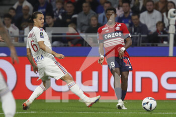 2022-10-30 - Jonathan DAVID of Lille and Maxence CAQUERET of Lyon during the French championship Ligue 1 football match between Olympique Lyonnais (Lyon) and LOSC Lille on October 30, 2022 at Groupama stadium in Decines-Charpieu near Lyon, France - FOOTBALL - FRENCH CHAMP - LYON V LILLE - FRENCH LIGUE 1 - SOCCER