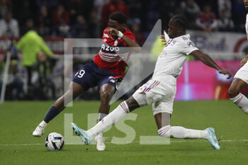 2022-10-30 - Jonathan DAVID of Lille and Castello LUKEBA of Lyon during the French championship Ligue 1 football match between Olympique Lyonnais (Lyon) and LOSC Lille on October 30, 2022 at Groupama stadium in Decines-Charpieu near Lyon, France - FOOTBALL - FRENCH CHAMP - LYON V LILLE - FRENCH LIGUE 1 - SOCCER