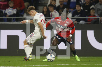 2022-10-30 - Jonathan BAMBA of Lille and Johann LEPENANT of Lyon during the French championship Ligue 1 football match between Olympique Lyonnais (Lyon) and LOSC Lille on October 30, 2022 at Groupama stadium in Decines-Charpieu near Lyon, France - FOOTBALL - FRENCH CHAMP - LYON V LILLE - FRENCH LIGUE 1 - SOCCER