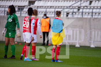 2022-02-27 - Tanya Romanenko of Stade de Reims is wearing the Ukraine flag ahead of the Women's French championship, D1 Arkema football match between Stade de Reims and Olympique Lyonnais (Lyon) on February 27, 2022 at Auguste Delaune stadium in Reims, France - STADE DE REIMS VS OLYMPIQUE LYONNAIS (LYON) - FRENCH WOMEN DIVISION 1 - SOCCER