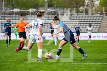 2022-04-15 - Morgane Nicoli of Montpellier Herault Sport Club and Mathilde Bourdieu of Paris FC fight for the ball during the Women's French championship D1 Arkema football match between Paris FC and Montpellier HSC on April 15, 2022 at Charlety stadium in Paris, France - PARIS FC VS MONTPELLIER HSC - FRENCH WOMEN DIVISION 1 - SOCCER