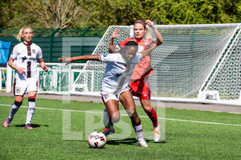 2022-04-17 - Claudine Falonne Meffometou of FC Fleury and Eugenie Le Sommer of Olympique Lyonnais fight for the ball during the Women's French championship, D1 Arkema football match between FC Fleury 91 and Olympique Lyonnais (Lyon) on April 17, 2022 at Walter Felder stadium in Fleury-Merogis, France - FC FLEURY 91 VS OLYMPIQUE LYONNAIS (LYON) - FRENCH WOMEN DIVISION 1 - SOCCER