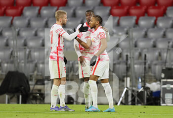 2022-02-05 - Christopher Nkunku of RB Leipzig celebrates after his goal 2-2 with Konrad Laimer, Nordi Mukiele during the German championship Bundesliga football match between Bayern Munich and RB Leipzig on February 5, 2022 at Allianz Arena in Munich, Germany - BAYERN MUNICH VS RB LEIPZIG - GERMAN BUNDESLIGA - SOCCER