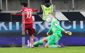 2022-02-26 - Kingsley Coman of Bayern Munich in duel with Kevin Trapp of Frankfurt during the German championship Bundesliga football match between Eintracht Frankfurt and Bayern Munich on February 26, 2022 at Deutsche Bank Park in Frankfurt, Germany - EINTRACHT FRANKFURT VS BAYERN MUNICH - GERMAN BUNDESLIGA - SOCCER