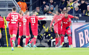 2022-04-02 - Christopher Nkunku (18) of Leipzig celebrates after his goal 0-3 with Nordi Mukiele and Mohamed Simakan during the German championship Bundesliga football match between Borussia Dortmund and RB Leipzig on April 2, 2022 at Signal Iduna Park in Dortmund, Germany - BORUSSIA DORTMUND VS RB LEIPZIG - GERMAN BUNDESLIGA - SOCCER