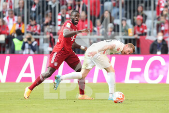 2022-04-09 - Dayot Upamecano of Bayern Munich and Andre Hahn of Augsburg during the German championship Bundesliga football match between Bayern Munich and FC Augsburg on April 9, 2022 at Allianz Arena in Munich, Germany - BAYERN MUNICH VS FC AUGSBURG - GERMAN BUNDESLIGA - SOCCER