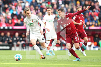 2022-04-09 - Arne Maier of Augsburg and Benjamin Pavard of Bayern Munich during the German championship Bundesliga football match between Bayern Munich and FC Augsburg on April 9, 2022 at Allianz Arena in Munich, Germany - BAYERN MUNICH VS FC AUGSBURG - GERMAN BUNDESLIGA - SOCCER