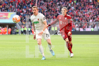 2022-04-09 - Andre Hahn of Augsburg and Marcel Sabitzer of Bayern Munich during the German championship Bundesliga football match between Bayern Munich and FC Augsburg on April 9, 2022 at Allianz Arena in Munich, Germany - BAYERN MUNICH VS FC AUGSBURG - GERMAN BUNDESLIGA - SOCCER