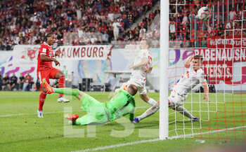 2022-07-30 - Serge Gnabry of Bayern Munich scores a goal 1-4, Peter Gulacsi of RB Leipzig during the German Super Cup football match between RB Leipzig and Bayern Munich on July 30, 2022 at Red Bull Arena in Leipzig, Germany - FOOTBALL - GERMAN SUPER CUP - RB LEIPZIG V BAYERN MUNICH - GERMAN SUPERCUP - SOCCER