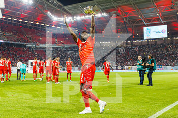 2022-07-30 - Alphonso Davies of Bayern Munich celebrates with the trophy during the German Super Cup football match between RB Leipzig and Bayern Munich on July 30, 2022 at Red Bull Arena in Leipzig, Germany - FOOTBALL - GERMAN SUPER CUP - RB LEIPZIG V BAYERN MUNICH - GERMAN SUPERCUP - SOCCER