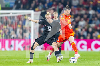 2022-03-24 - Wales' forward Gareth Bale (C) (11) under pressure from Austria's midfielder Xaver Schlager (23) during the 2022 Fifa World Cup, Qualifiers Play-off, Semi Final football match between Wales and Austria on March 24, 2022 at the Cardiff City Stadium in Cardiff, Wales - 2022 FIFA WORLD CUP, QUALIFIERS PLAY-OFF, SEMI FINAL - WALES VS AUSTRIA - FIFA WORLD CUP - SOCCER