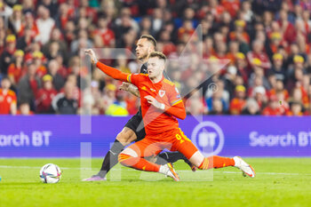 2022-03-24 - Wales' defender Joe Rodon (6) tackles Austria's forward Marko Arnautovic (7) during the 2022 Fifa World Cup, Qualifiers Play-off, Semi Final football match between Wales and Austria on March 24, 2022 at the Cardiff City Stadium in Cardiff, Wales - 2022 FIFA WORLD CUP, QUALIFIERS PLAY-OFF, SEMI FINAL - WALES VS AUSTRIA - FIFA WORLD CUP - SOCCER