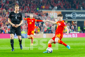 2022-03-24 - Wales' forward Daniel James (20) under pressure from Austria's defender Martin Hinteregger (4) during the 2022 Fifa World Cup, Qualifiers Play-off, Semi Final football match between Wales and Austria on March 24, 2022 at the Cardiff City Stadium in Cardiff, Wales - 2022 FIFA WORLD CUP, QUALIFIERS PLAY-OFF, SEMI FINAL - WALES VS AUSTRIA - FIFA WORLD CUP - SOCCER