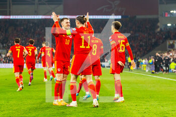 2022-03-24 - Wales? forward Gareth Bale celebrates scoring his side's second goal 2-0 with Aaron Ramsey during the 2022 Fifa World Cup, Qualifiers Play-off, Semi Final football match between Wales and Austria on March 24, 2022 at the Cardiff City Stadium in Cardiff, Wales - 2022 FIFA WORLD CUP, QUALIFIERS PLAY-OFF, SEMI FINAL - WALES VS AUSTRIA - FIFA WORLD CUP - SOCCER