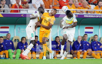 2022-11-21 - Denzel Dumfries of Netherlands and Cheikhou Kouyate, Ismaila Sarr of Senegal during the FIFA World Cup 2022, Group A football match between Senegal and Netherlands on November 21, 2022 at Al Thumama Stadium in Doha, Qatar - FOOTBALL - WORLD CUP 2022 - SENEGAL V NETHERLANDS - FIFA WORLD CUP - SOCCER