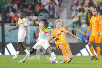 2022-11-21 - Idrissa Gana Gueye of Senegal and Frenkie de Jong of Netherlands during the FIFA World Cup 2022, Group A football match between Senegal and Netherlands on November 21, 2022 at Al Thumama Stadium in Doha, Qatar - FOOTBALL - WORLD CUP 2022 - SENEGAL V NETHERLANDS - FIFA WORLD CUP - SOCCER