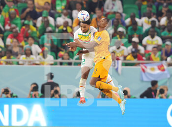 2022-11-21 - Abdou Diallo of Senegal, Denzel Dumfries of Netherlands during the FIFA World Cup 2022, Group A football match between Senegal and Netherlands on November 21, 2022 at Al Thumama Stadium in Doha, Qatar - FOOTBALL - WORLD CUP 2022 - SENEGAL V NETHERLANDS - FIFA WORLD CUP - SOCCER