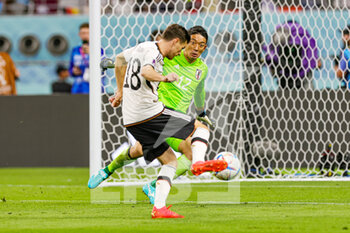 2022-11-23 - Shuichi Gonda (12) of Japan gets ready to stop the shot from Jonas Hofmann (18) of Germany during the FIFA World Cup 2022, Group E football match between Germany and Japan on November 23, 2022 at Khalifa International Stadium in Ar-Rayyan, Qatar - FOOTBALL - WORLD CUP 2022 - GERMANY V JAPAN - FIFA WORLD CUP - SOCCER