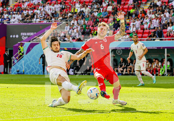 2022-11-25 - Sardar Azmoun (20) of Iran streches for the ball on goal defended by Joe Rodon (6) of Wales during the Fifa World Cup 2022, Group B football match between Wales and Iran on November 25, 2022 at Ahmad bin Ali Stadium in Al Rayyan, Qatar - FOOTBALL - WORLD CUP 2022 - WALES V IRAN - FIFA WORLD CUP - SOCCER