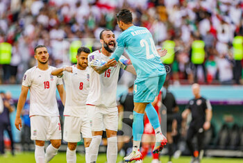 2022-11-25 - Rouzbeh Cheshmi (15) of Iran celebrates with Hossein Hosseini at full time during the Fifa World Cup 2022, Group B football match between Wales and Iran on November 25, 2022 at Ahmad bin Ali Stadium in Al Rayyan, Qatar - FOOTBALL - WORLD CUP 2022 - WALES V IRAN - FIFA WORLD CUP - SOCCER