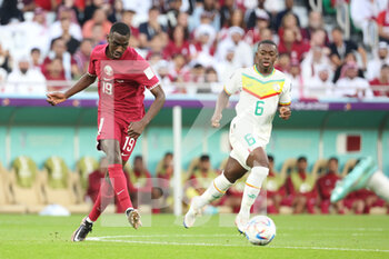 2022-11-25 - Almoez Ali of Qatar, Nampalys Mendy of Senegal during the FIFA World Cup 2022, Group A football match between Qatar and Senegal on November 25, 2022 at Al Thumama Stadium in Doha, Qatar - FOOTBALL - WORLD CUP 2022 - QATAR V SENEGAL - FIFA WORLD CUP - SOCCER