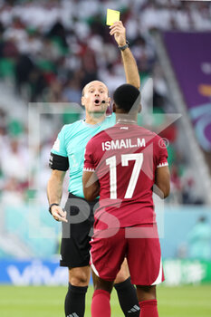 2022-11-25 - Referee Antonio Mateu Lahoz of Spain gives a yellow card to Ismaeel Mohamad of Qatar during the FIFA World Cup 2022, Group A football match between Qatar and Senegal on November 25, 2022 at Al Thumama Stadium in Doha, Qatar - FOOTBALL - WORLD CUP 2022 - QATAR V SENEGAL - FIFA WORLD CUP - SOCCER