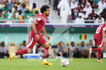 2022-11-25 - Akram Afif of Qatar during the FIFA World Cup 2022, Group A football match between Qatar and Senegal on November 25, 2022 at Al Thumama Stadium in Doha, Qatar - FOOTBALL - WORLD CUP 2022 - QATAR V SENEGAL - FIFA WORLD CUP - SOCCER