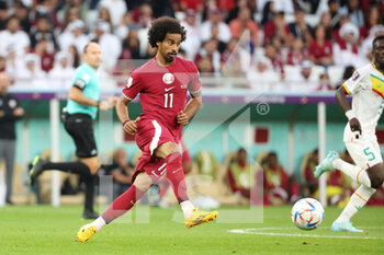 2022-11-25 - Akram Afif of Qatar during the FIFA World Cup 2022, Group A football match between Qatar and Senegal on November 25, 2022 at Al Thumama Stadium in Doha, Qatar - FOOTBALL - WORLD CUP 2022 - QATAR V SENEGAL - FIFA WORLD CUP - SOCCER