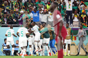 2022-11-25 - Boulaye Dia of Senegal celebrates his goal with teammates during the FIFA World Cup 2022, Group A football match between Qatar and Senegal on November 25, 2022 at Al Thumama Stadium in Doha, Qatar - FOOTBALL - WORLD CUP 2022 - QATAR V SENEGAL - FIFA WORLD CUP - SOCCER