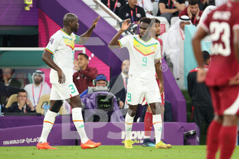 2022-11-25 - Boulaye Dia of Senegal celebrates his goal with Kalidou Koulibaly (left) during the FIFA World Cup 2022, Group A football match between Qatar and Senegal on November 25, 2022 at Al Thumama Stadium in Doha, Qatar - FOOTBALL - WORLD CUP 2022 - QATAR V SENEGAL - FIFA WORLD CUP - SOCCER