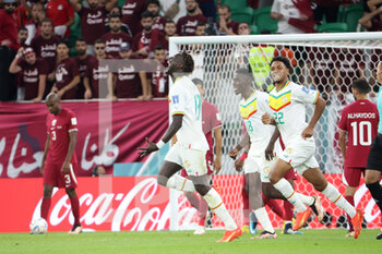 2022-11-25 - Famara Diedhiou of Senegal celebrates his goal with Ismaila Sarr, Abdou Diallo during the FIFA World Cup 2022, Group A football match between Qatar and Senegal on November 25, 2022 at Al Thumama Stadium in Doha, Qatar - FOOTBALL - WORLD CUP 2022 - QATAR V SENEGAL - FIFA WORLD CUP - SOCCER